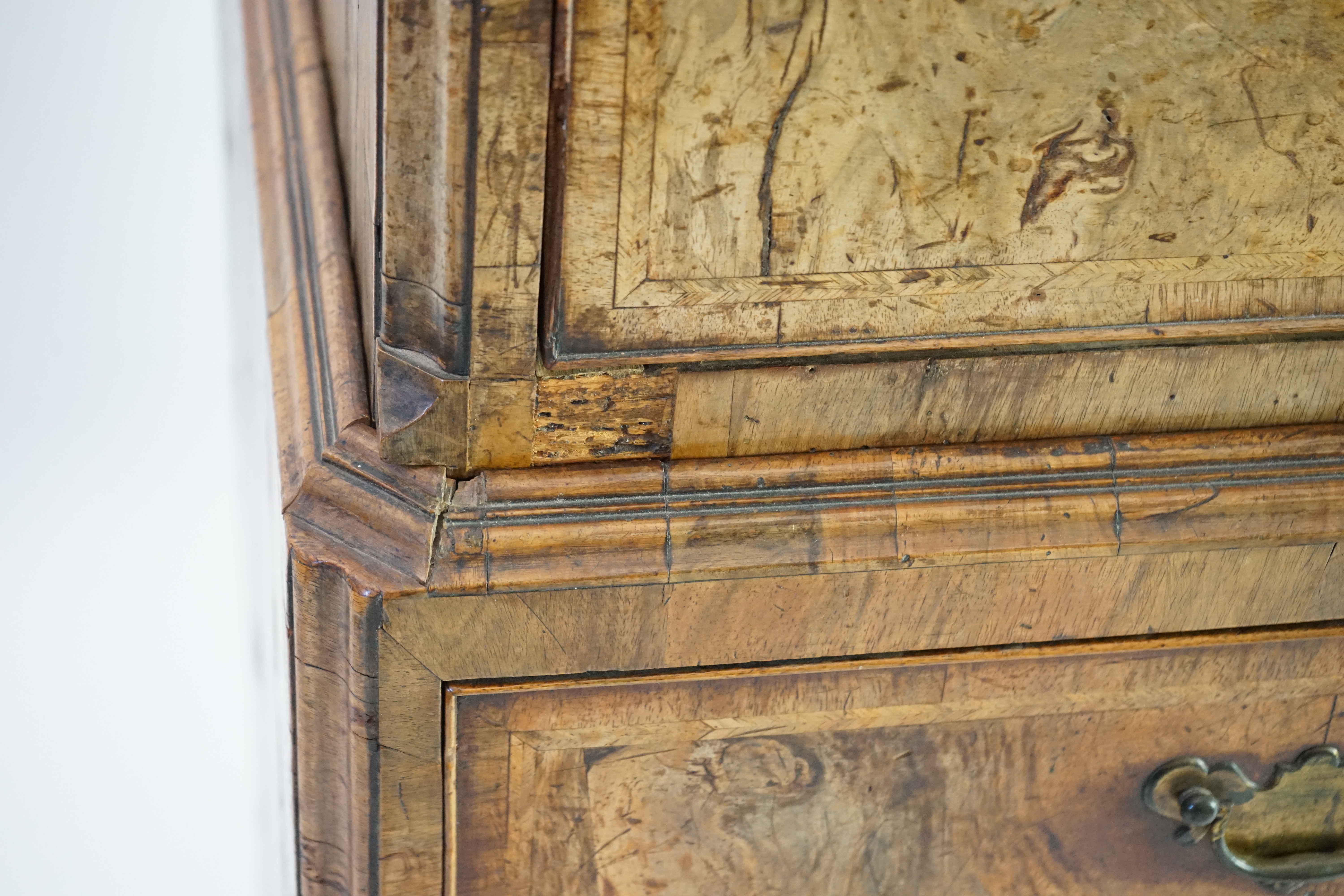 A George II feather banded walnut chest on chest